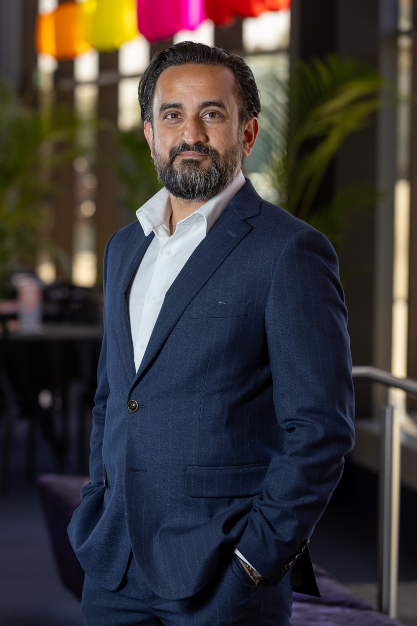 Sami Shah in a navy suit